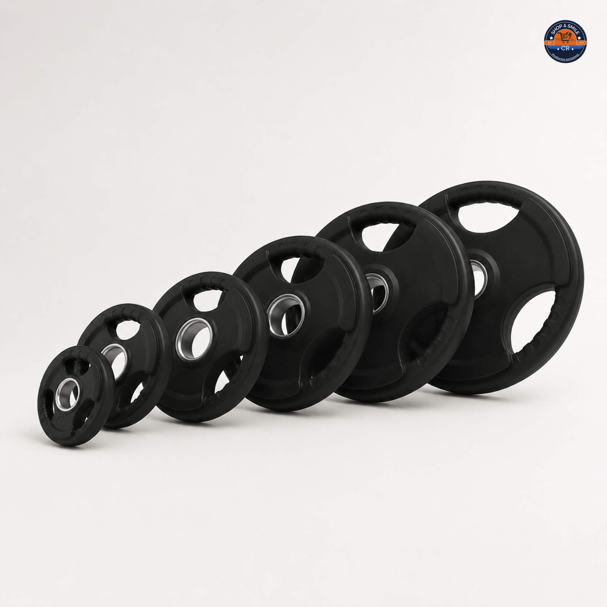 Pares de discos olímpicos de hierro con recubrimiento de hule disponibles de 2,5 a 25 kg por disco